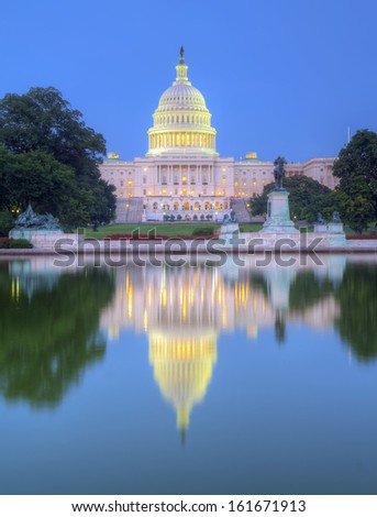 HDR image of the west side of the United States Capitol building and Ulysses S Grant memorial reflected in the reflecting pool just after sunset vertical