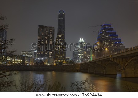 HDR image of a partial skyline of Austin, Texas over the water of Lady Bird Lake at night