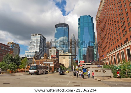 MINNEAPOLIS, MINNESOTA - AUGUST 11 2014: Pedestrian and car traffic moves through downtown Minneapolis, the seat of Hennepin County and the largest city in Minnesota with over 400,000 residents.