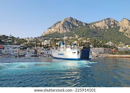 CAPRI, ITALY - OCTOBER 10 2014: Caremar ferry Naiade arriving at Marina Grande on the isle of Capri. Ferries provide transport of passengers and vehicles to many destinations in the Gulf of Naples.