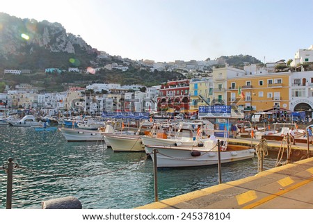CAPRI, ITALY - OCTOBER 10 2014: Tour boat operators and buildings at Marina Grande on the island of Capri. Boats leaving from pier 0 provide tours all over the island including the famous Blue Grotto.