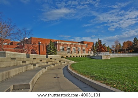 Schwitzer Student Center and part of an outdoor amphitheater on the campus of the University of Indianapolis in Indiana with blue sky and white clouds