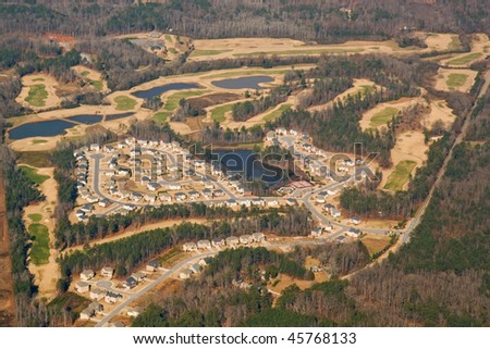 Aerial view of a golf course and housing development near Atlanta, Georgia in winter with trees