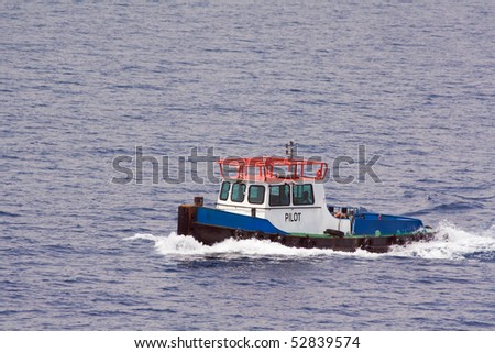 Pilot boat coming to guide a cruise ship into port