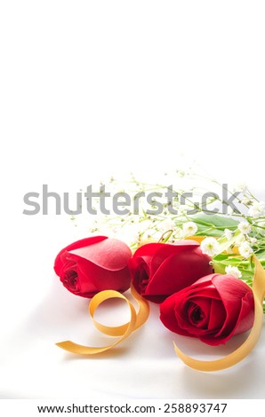 Red roses with gold ribbon