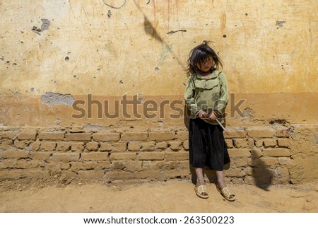 SAPA, VIETNAM - MARCH 16: An unidentified child standing near wall at rural school compound on March 16, 2015 in Sin Chai village of Sapa.