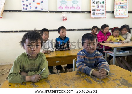 SAPA, VIETNAM - MARCH 16: A group of unidentified students attend lesson in rural school on March 16, 2015 in Sin Chai village of Sapa. Taken with high ISO.