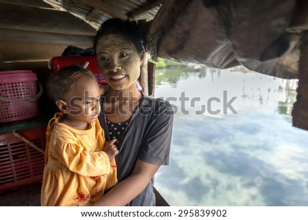 SEMPORNA, MALAYSIA - JUN 27 : Unidentified Sea Bajau\'s family posing inside their makeshift hut Jun 27, 2015 in Sabah, Malaysia. The Bajau Laut are the sea gypsies who live in the open sea.