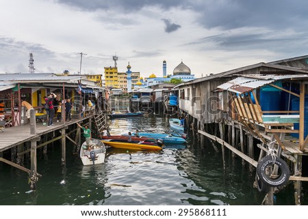 SEMPORNA, MALAYSIA - JUN 27 : Rural living on wooden stilt houses at fishing port with mosque nearby Jun 27, 2015 in Sabah, Malaysia.