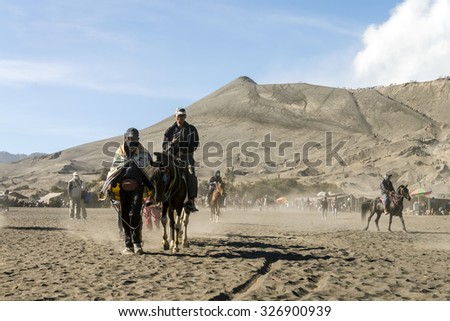 MOUNT BROMO VOLCANO, INDONESIA - SEP 20: Horseman lead tourist on horse at Mount Bromo in late morning on Sep 20, 2015 in East Java, Indonesia.