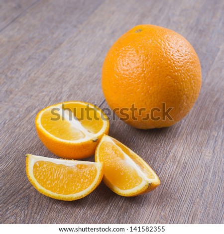 Orange fruits against dark oak table