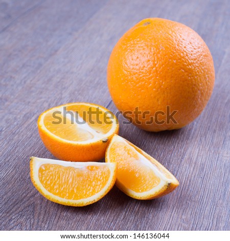 Orange fruits against dark oak table