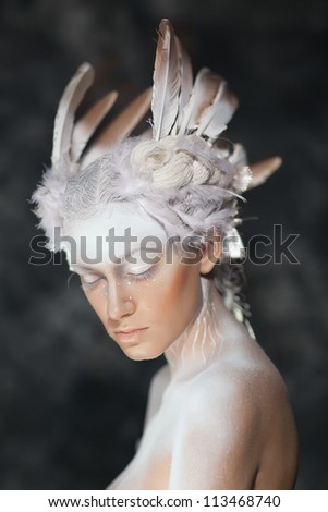 Young beautiful fashion model with creative makeup close-up portrai.White Swan, the ballet.Halloween