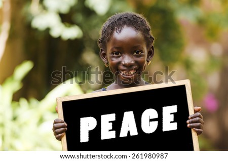 Peace On Earth - African Girl Holding Chalkboard. African girl holding a big peace symbol.