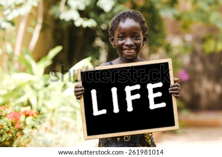 Life Symbol - African Girl with a Blackboard. Life Symbol - African Girl with a Blackboard in the streets of Bamako, Mali.