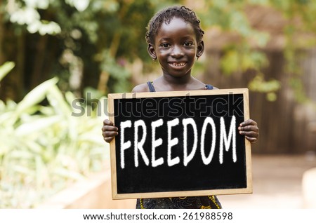 Freedom Symbol - African Girl Holding Chalkboard. An African girl holding a chalkboard.