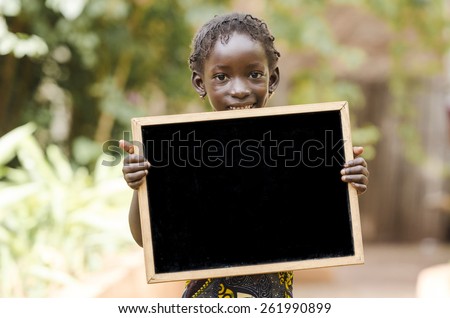 Copy Space for your text - African Girl Holding Blackboard. An African girl holding a blackboard, with plenty of copy space.