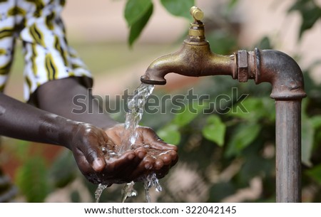 Climate Change Symbol: Handful Of Water Scarsity for Africa Symbol. Hand of an African black boy with water pouring from a tap.