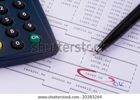 calculator and a pen on an account print-out