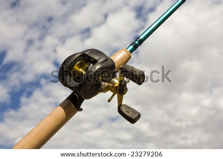 Bait cast reel on a new rod with a sky as background