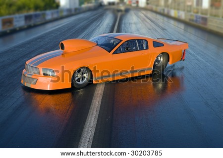 Brand new orange dragster placed on the race course