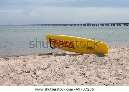 Yellow surf board ready to rescue people from drowning