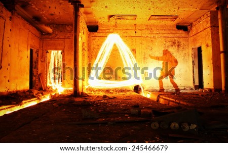 Magic light painted triangle in dark abandoned underground room