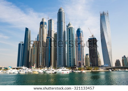 DUBAI - NOVEMBER 16: Dubai Marina skyline. Dubai Marina yachts. Dubai Marina skyscrapers, Cayan Tower, Princess Tower, The Torch Tower, Marina 101 on November 16, 2014 in Dubai