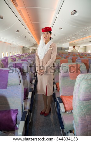 Dubai, UAE - NOVEMBER 9, 2015: Emirates Airbus A380 cabin crew member. Emirates A380 economy class seats. Emirates flight attendant on November 09, 2015 in Dubai