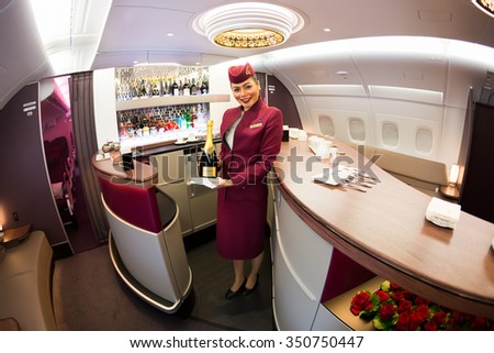 Dubai, UAE - NOVEMBER 10, 2015: Qatar Airways Airbus A380 cabin crew member, Qatar Airways flight attendant, Qatar Airways stewardess, Airbus A380 upper deck lounge on November 10, 2015 in Dubai