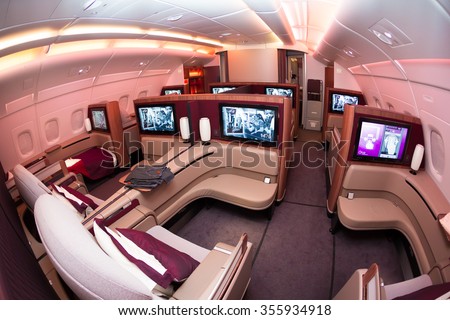 Dubai, UAE - NOVEMBER 10, 2015: Qatar Airways Airbus A380 first class luxury seats. ORYX inflight entertainment IFE. Airbus A380 cabin, business class travelling on November 10, 2015 in Dubai