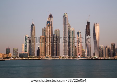 Dubai skyline. Dubai cityscape. Dubai Marina skyscrapers Cayan Tower, Princess Tower, Marina 101. Dubai evening skyline.Dubai Marina skyline.Dubai iconic view.Palm Jumeirah views. Dubai sunset colors.