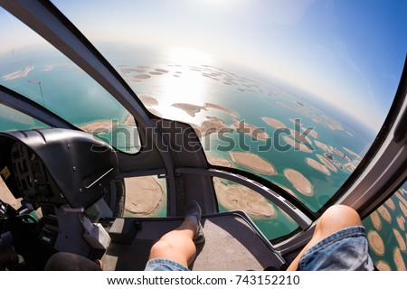 Helicopter flight over the sea. Dubai leisure. Eurocopter EC130. Luxury lifestyle.