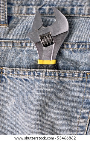 adjustable spanner in a blue jeans pocket
