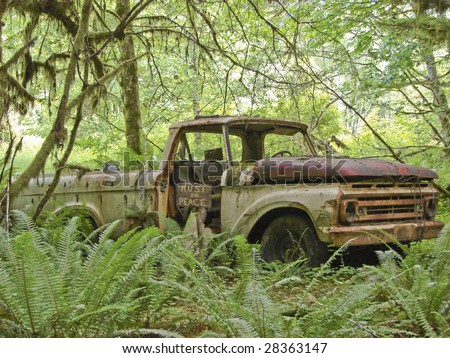 stock photo abandoned rusty truck with humorous sign