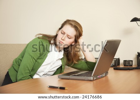 Young businesswoman stressed out at her computer