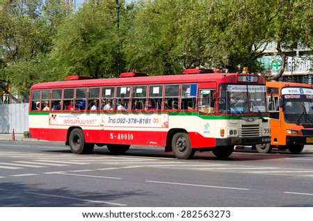 BANGKOK, THAILAND - MAY 16, 2015: People ride a city bus in Bangkok. Bangkok Mass Transit Authority (BMTA) operates more than 100 lines with fleet of 3,000 buses.