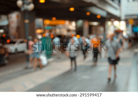out of focus picture of a crowd of people walking in the city