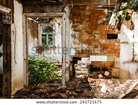 Interior of an abandoned house in ruins, with old window.