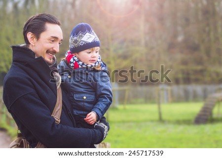father and son taking a walk in the city park