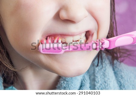 Girl cleans teeth of the face closeup