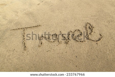 The Word \'travel\' Written in Sand Background