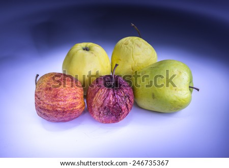 Five old apples painted with light