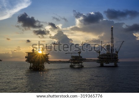 Offshore oil rigs or production platforms during sunset