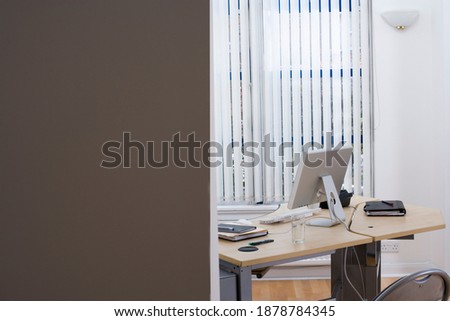 Horizontal shot of an unoccupied desk in an office cabin with copy space.