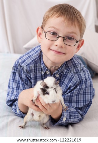 Young boy with guinea pig