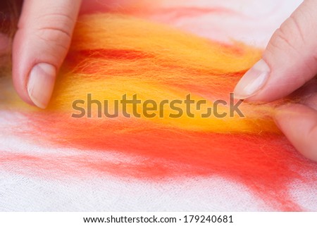 Felting activity - woman working with wool sliver