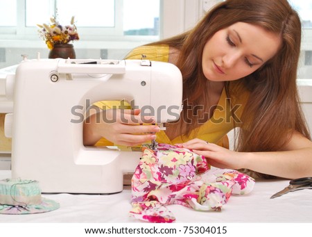 Woman seamstress work on the sewing-machine