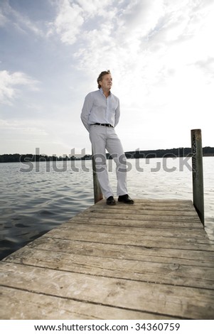 A handsome man in his fifties relaxing near by a sea