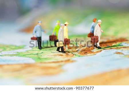 International Business Cooperation, a groupd of miniature businesspeople models walking across a map, low angle and shallw DOF.